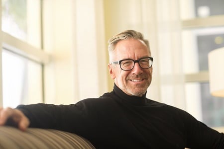Man smiling in a relaxed setting at Belle Medical.